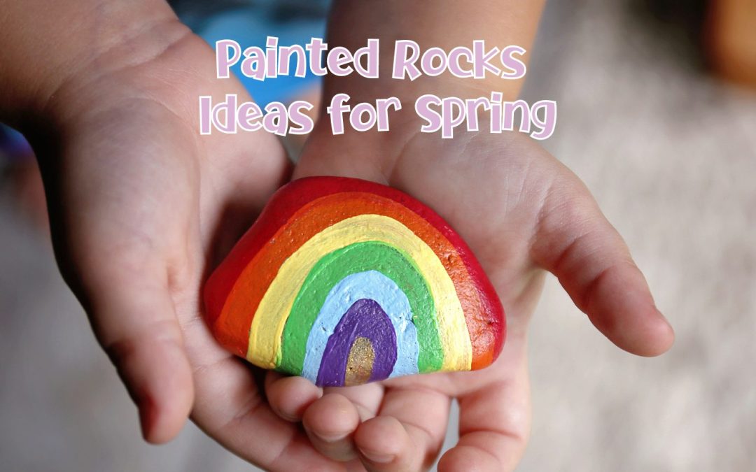 Person holds a rock that in their palms that is painted to look like a rainbow. Text above the image says Painted Rocks Ideas for Spring in light purple